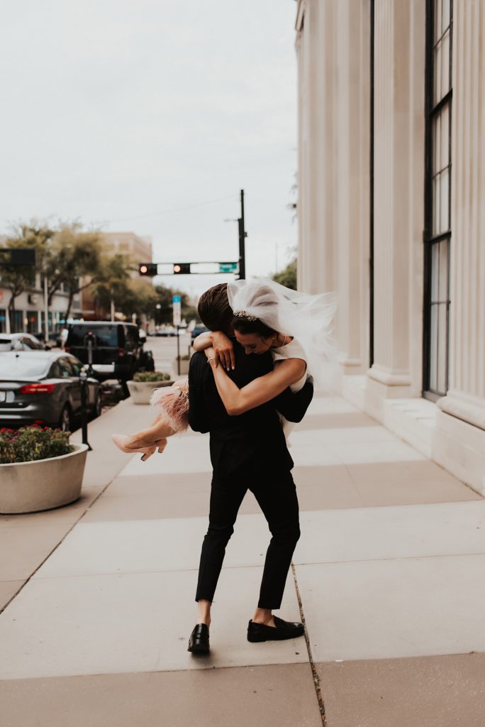 Bride jumping into grooms arms on downtown tampa street