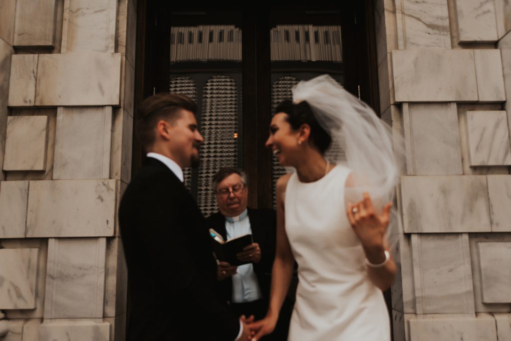 Bride and groom laughing during ceremony on Le Meridien Steps