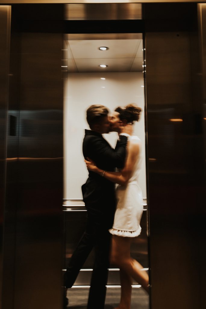 Bride and groom kissing in elevator in Le meridien tampa