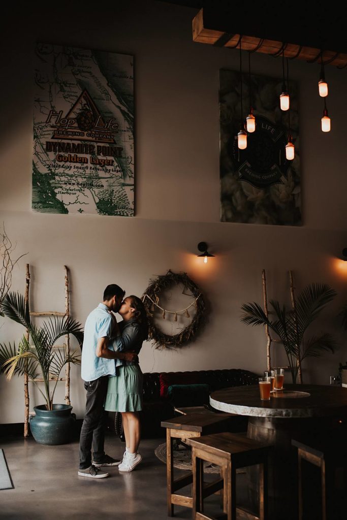 Couple kissing inside brewery