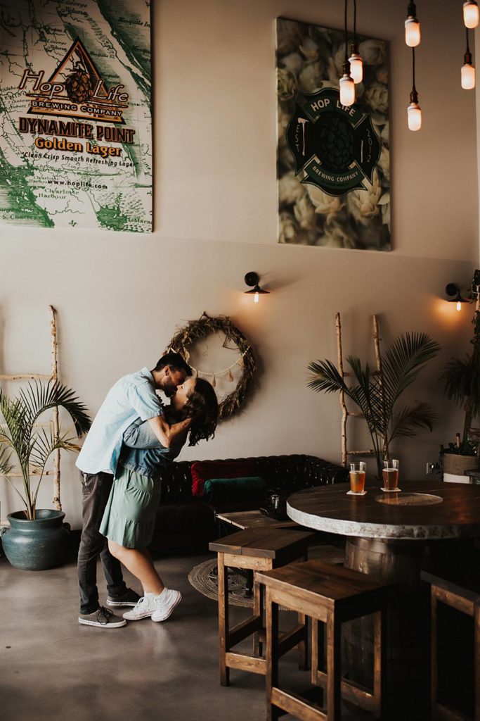 Couple kissing inside brewery