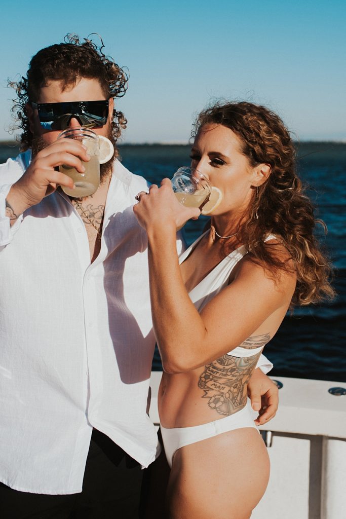 Bride and groom mixing cocktails on boat