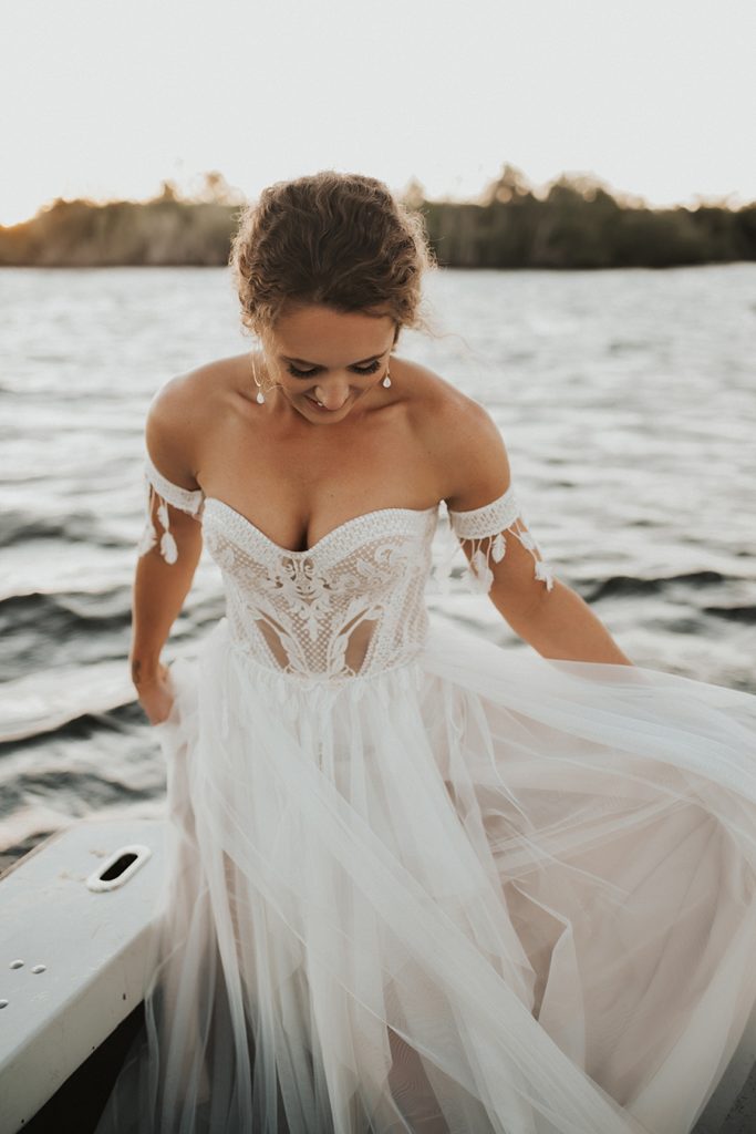 Bride in white lacy dress on boat