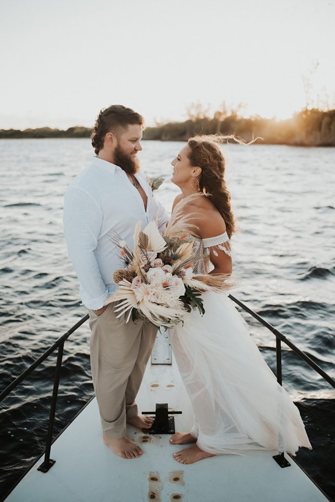 Bride and groom on front of boat