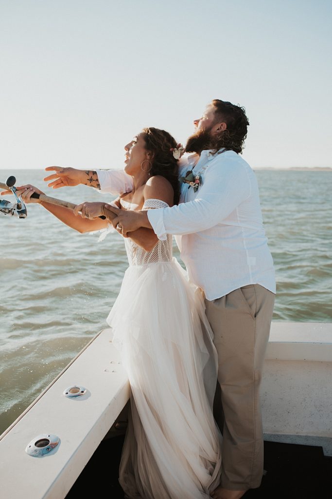 Bride and groom fishing on boat