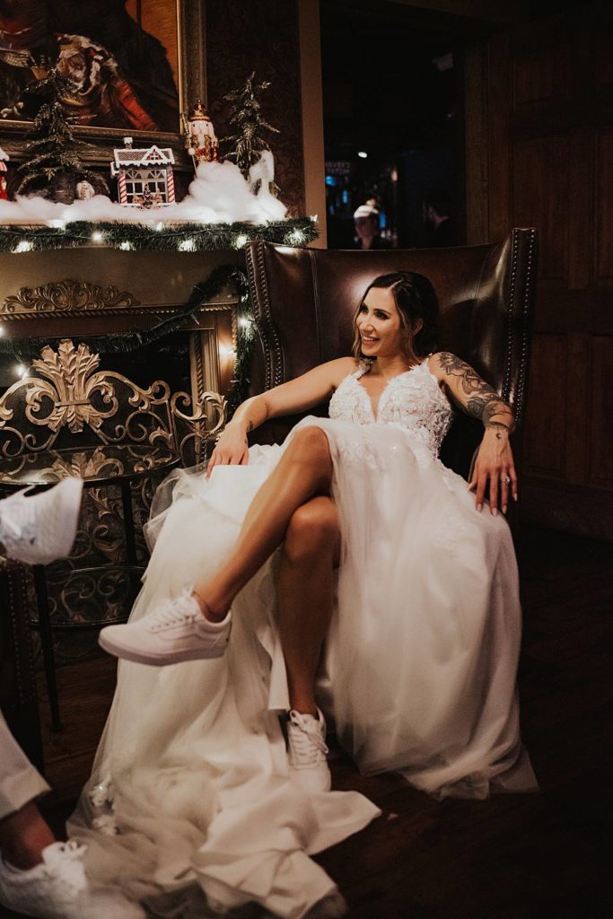 Bride sitting in front of fireplace at Tini Martini