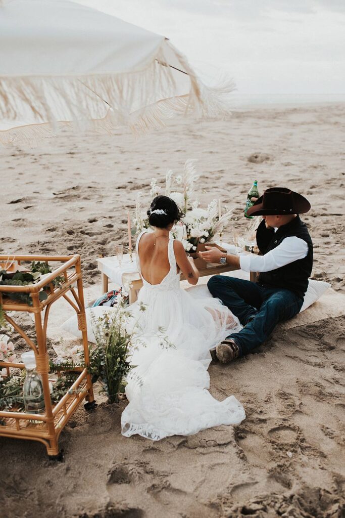Bride and groom enjoying their luxury picnic on the beach after their Florida elopement