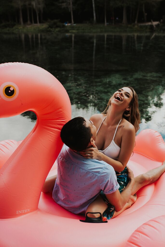 Couple sitting on giant flamingo float at Kelly Rock Springs after their Florida elopement